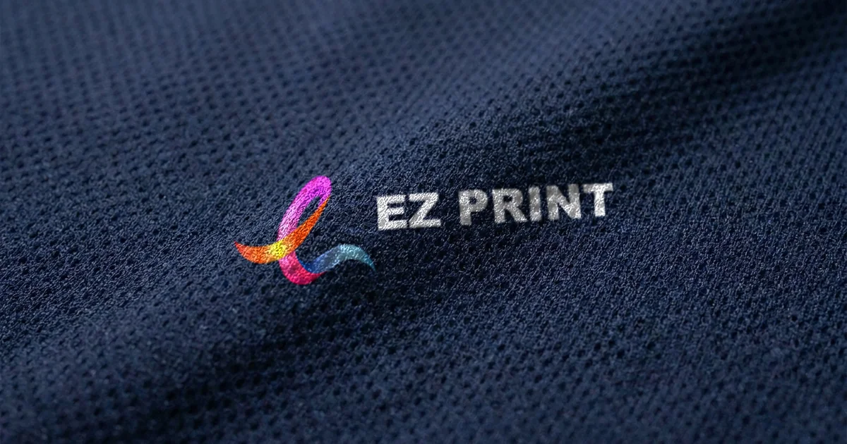 Close-up of navy dri-fit mesh fabric with the EZ Print logo applied as a transfer.