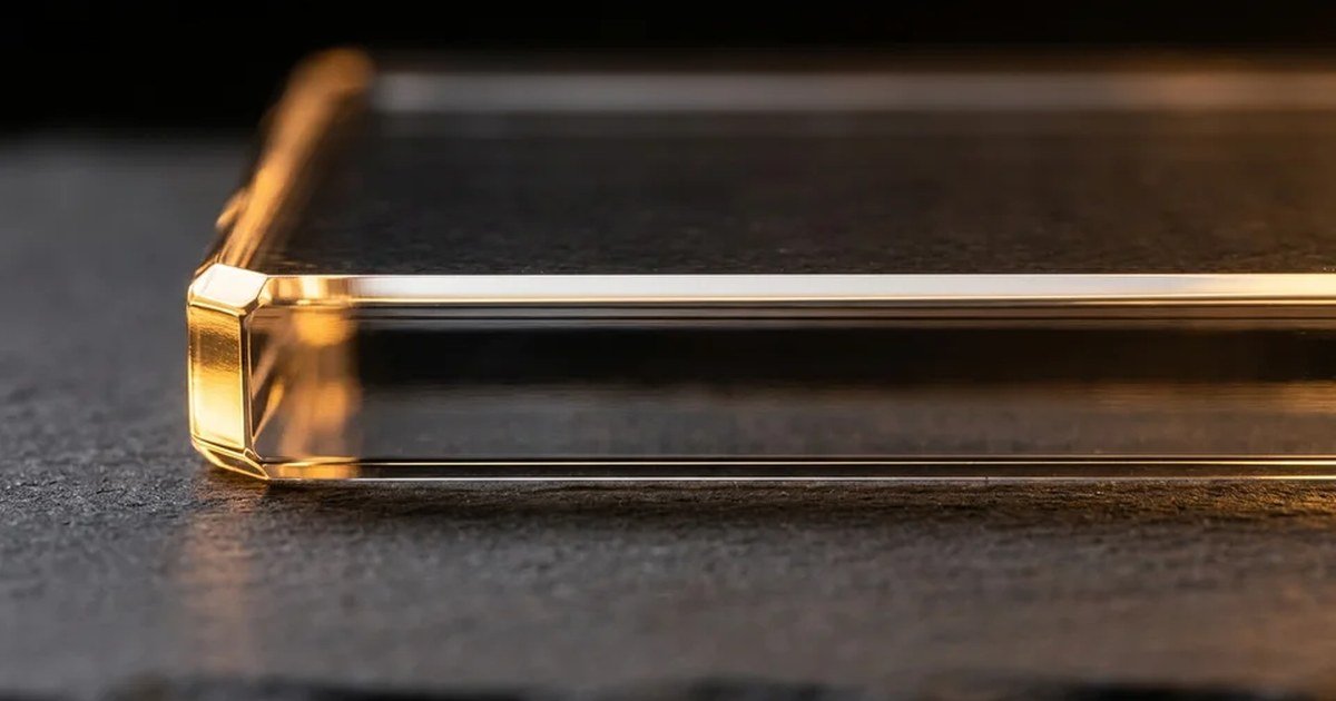 Illustration of the polished edge of a thick clear acrylic panel lit with warm light on a dark surface.