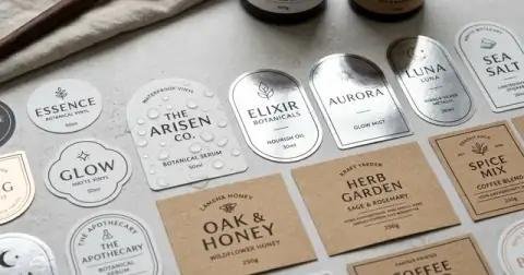 Collection of waterproof vinyl labels, metallic silver foil stickers, and textured kraft product labels.