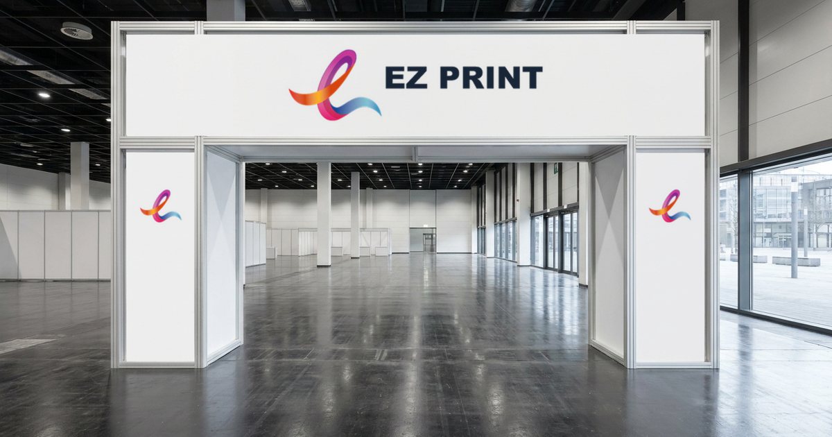White entrance gantry in an empty exhibition hall with the EZ Print logo on the header and the ribbon mark on both legs.