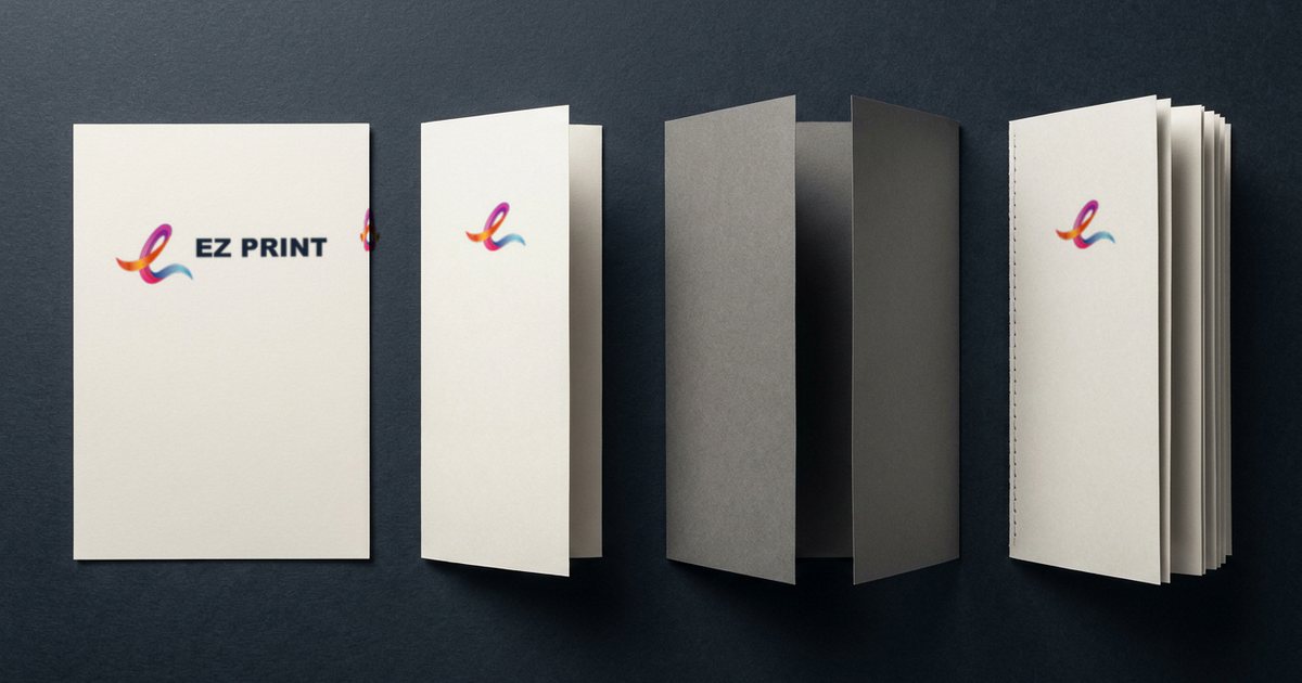 A flat flyer, a folded leaflet, a tri-fold brochure and a stapled pamphlet on a navy surface, three carrying the EZ Print logo.