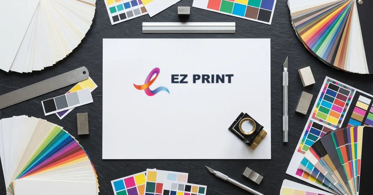Sheet printed with the EZ Print logo surrounded by paper swatches, colour charts, a loupe and a ruler.