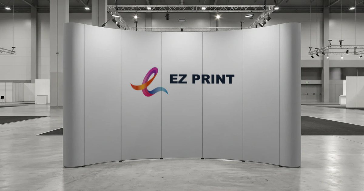 Curved pop-up display wall in an exhibition hall printed with the EZ Print logo across its panels.