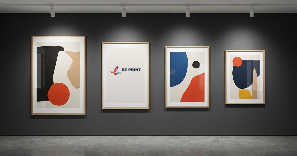 Four framed posters of different sizes on a gallery wall, one of them an EZ Print logo poster.