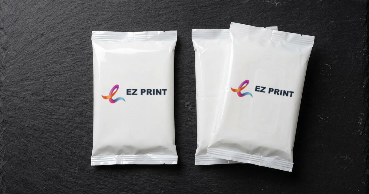 Two white pocket tissue packs on slate, each wrapper printed with the EZ Print logo.