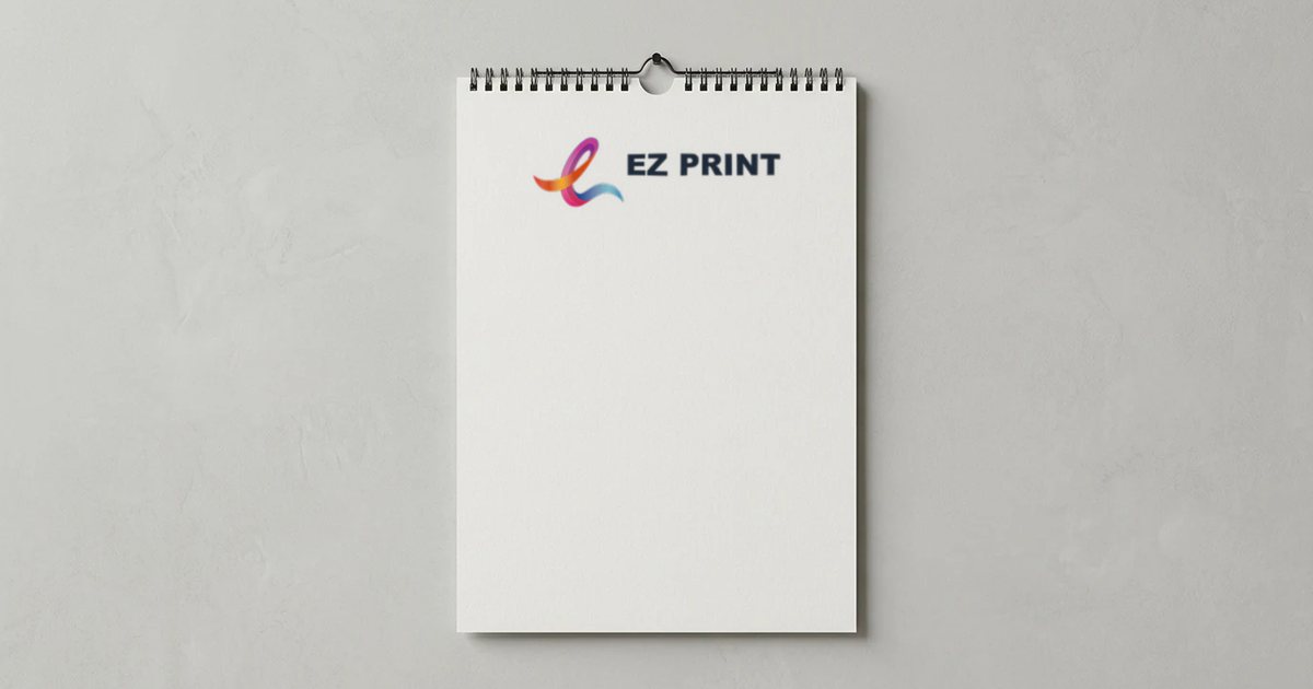 Wire-bound wall calendar hanging on a plain wall with the EZ Print logo printed at the top of the page.