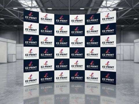 A curved tension fabric exhibition media backdrop with checkerboard EZ Print branding in an exhibition hall.