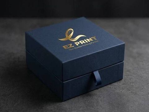 A luxury matte midnight-navy rigid gift box with gold foil debossed EZ Print mark on dark stone.