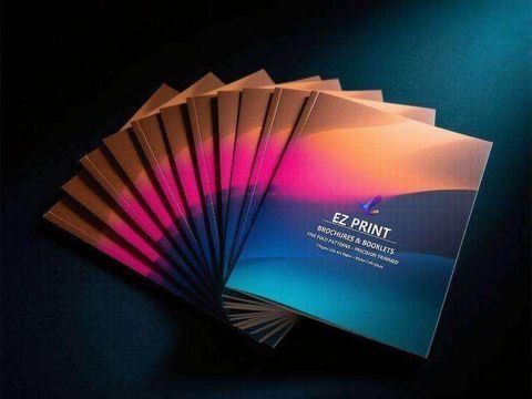 A fan of printed leaflets in magenta, amber and blue gradients.